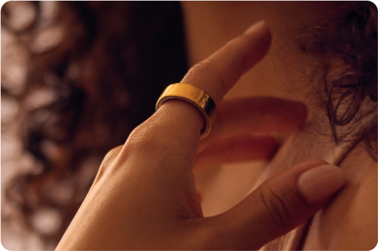 Person wearing the brand-new Oura Ring 4 Gold on their left pointer finger