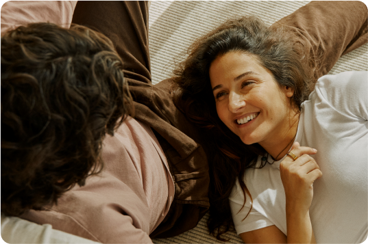 Woman looking up at someone wearing an Oura Ring