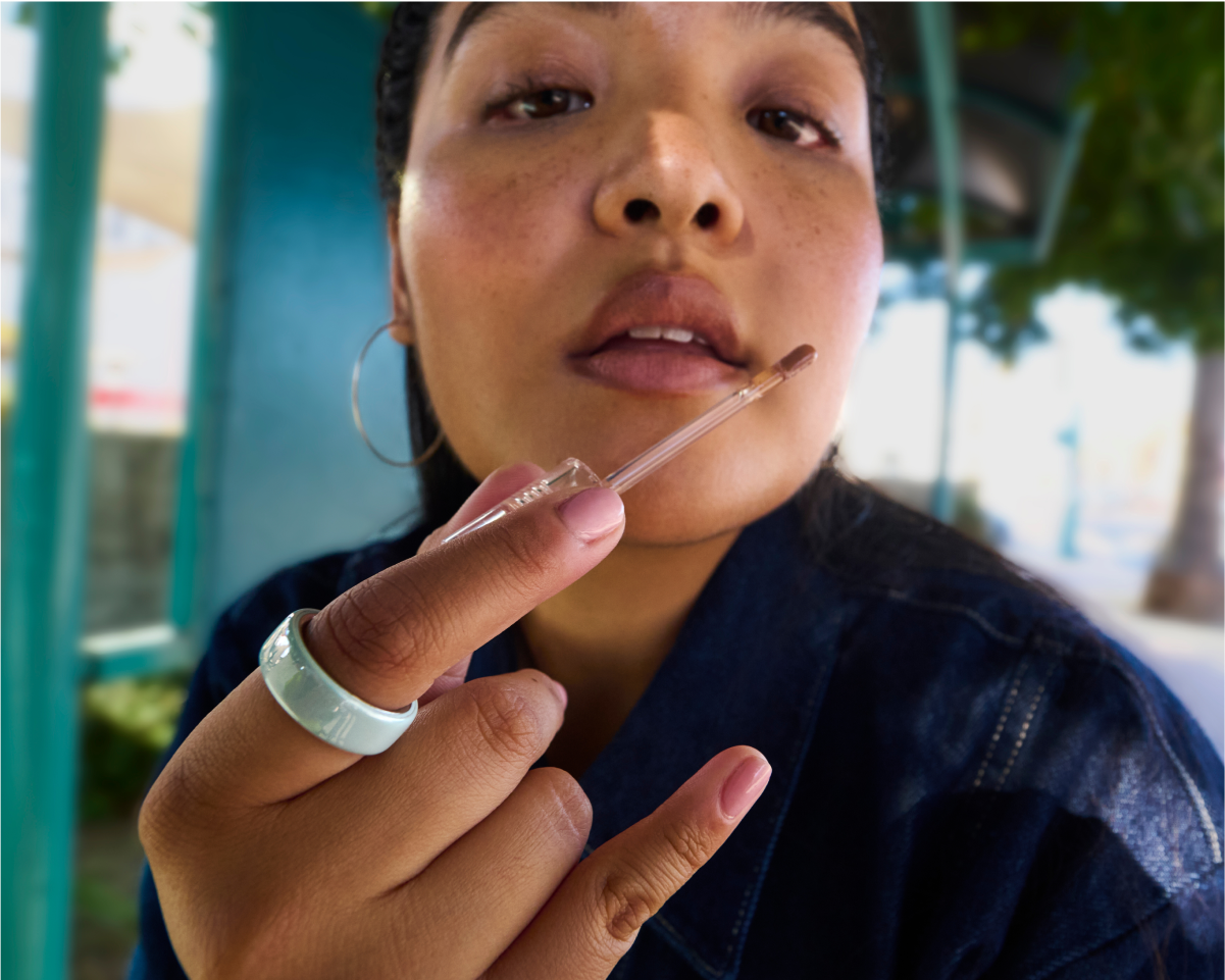 Hands holding phone with Oura app open