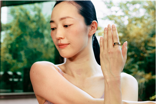 Female stretching wearing Oura Ring