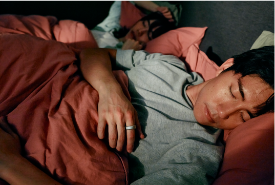 Male sleeping wearing Oura Ring