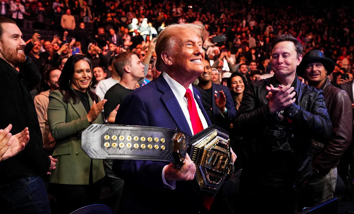 Trump holds UFC winning belt.