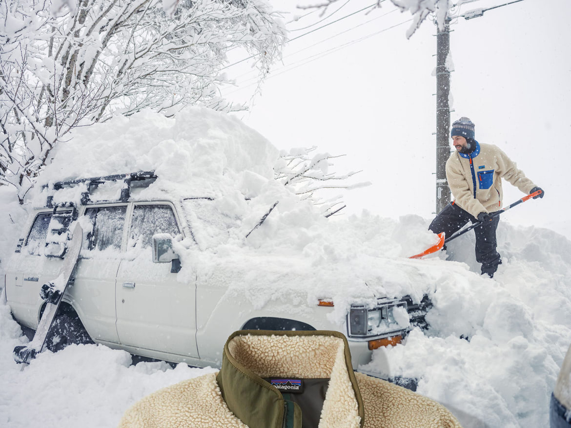Patagonia. A person shoveling snow away from a car