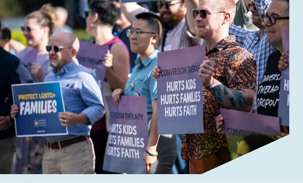 Demonstrators with Human Rights Campaign stand outside as the United States Supreme Court is set to hear free speech challenge to a ban on conversion therapy