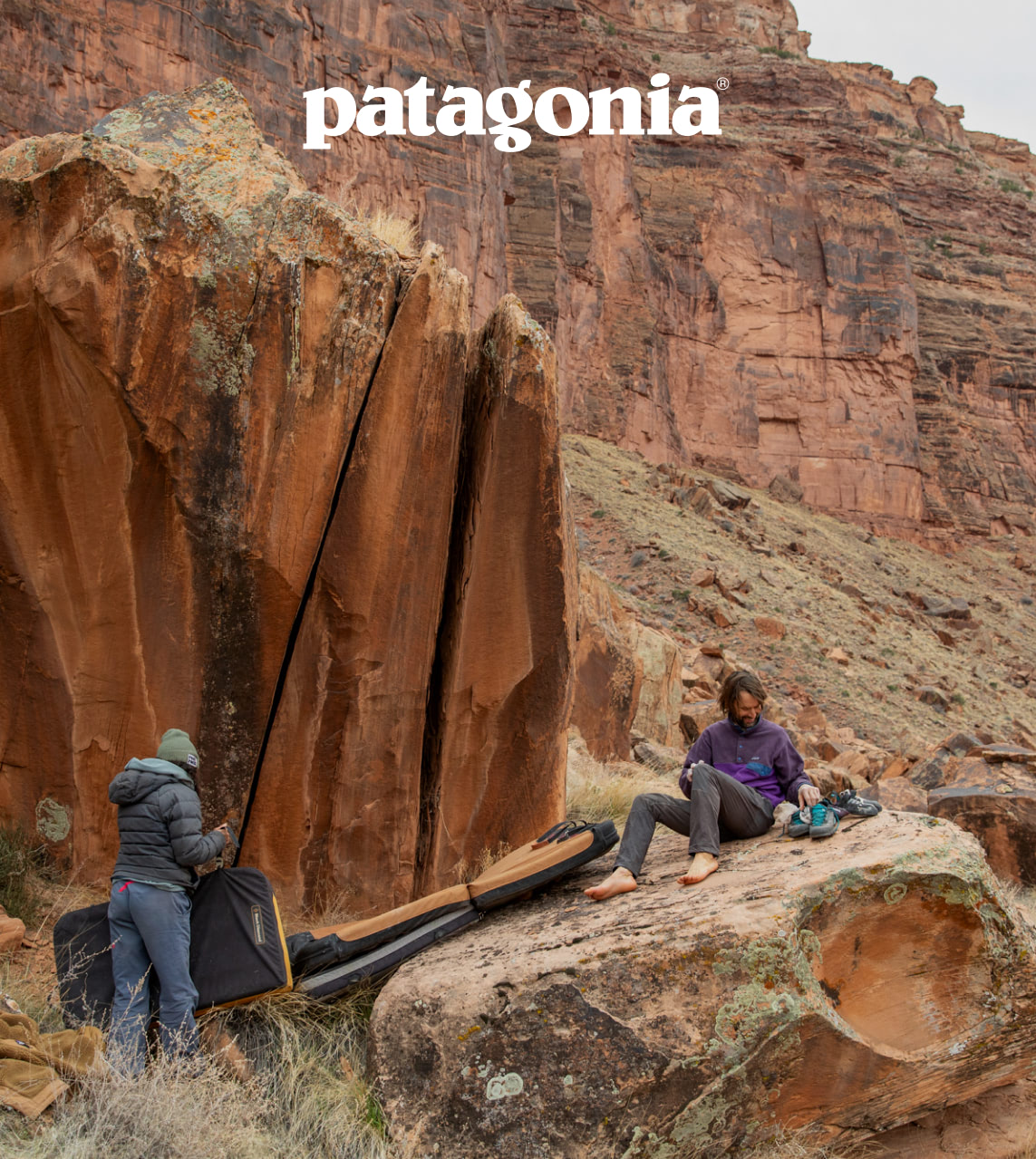 Patagonia. Two people prepare to climb a rock in a canyon.