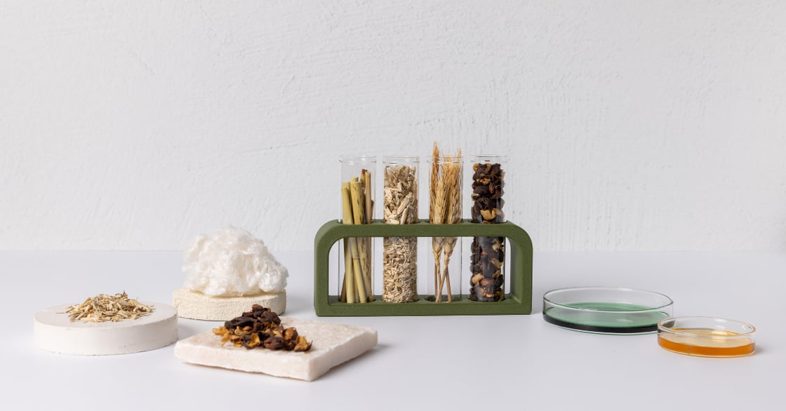 Several natural materials sit in tubes and on coasters.